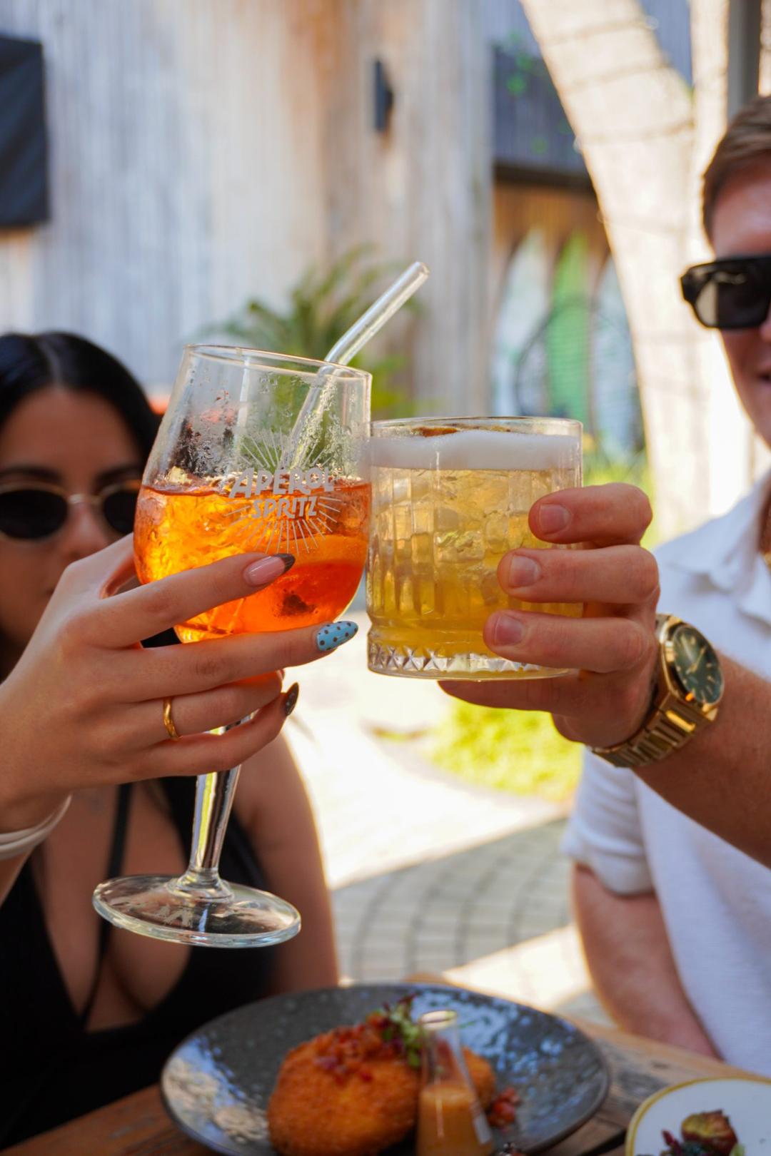 Friends toasting cocktails at Alchemy