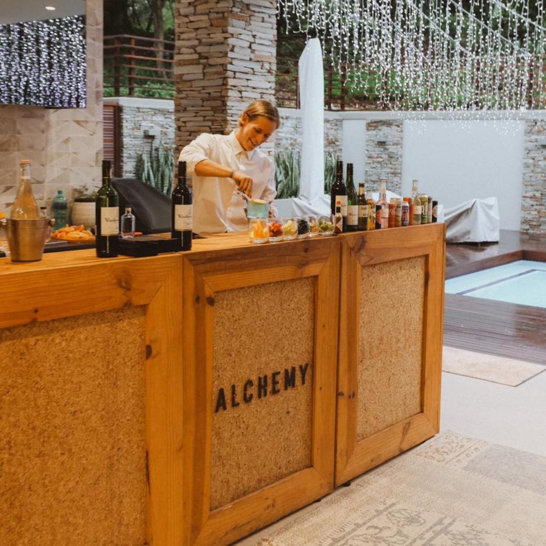 Alchemy bartender mixing cocktails at a mobile bar